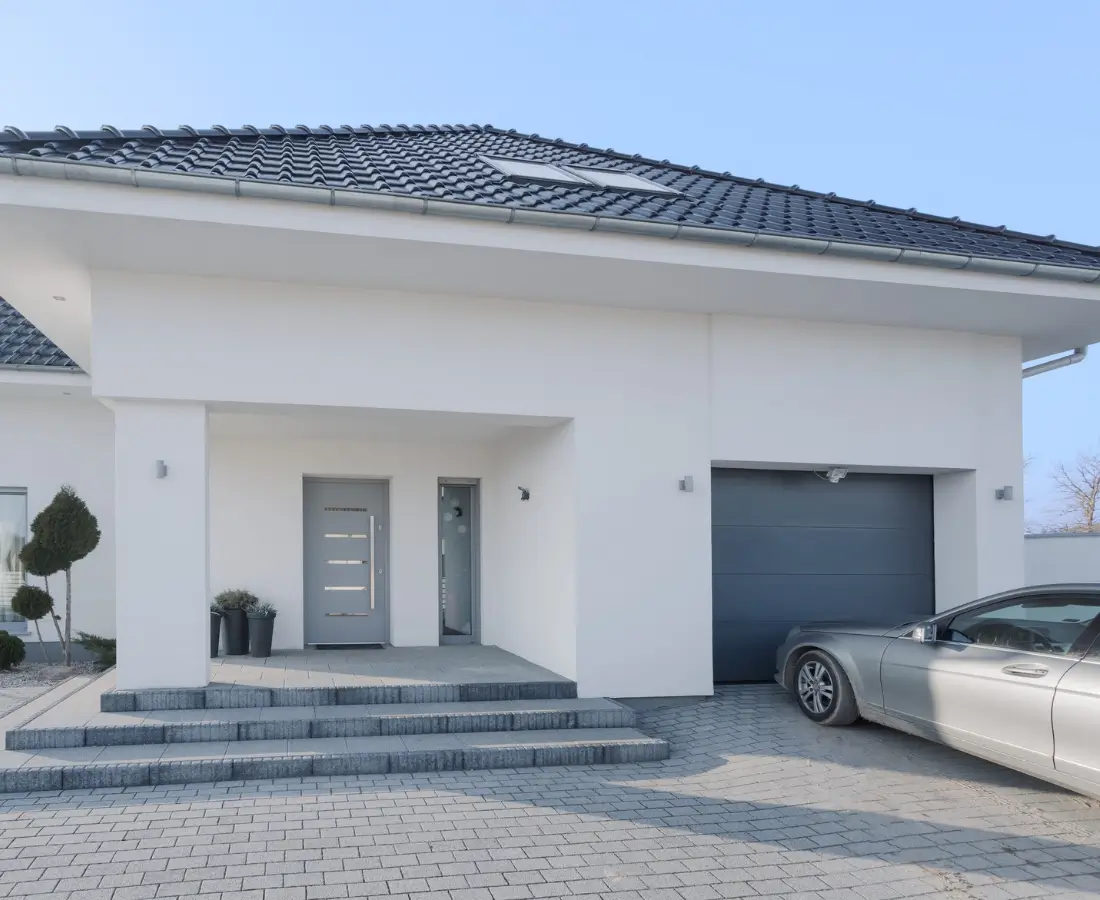 Simple, white entrance of a home with carport, the opportunities