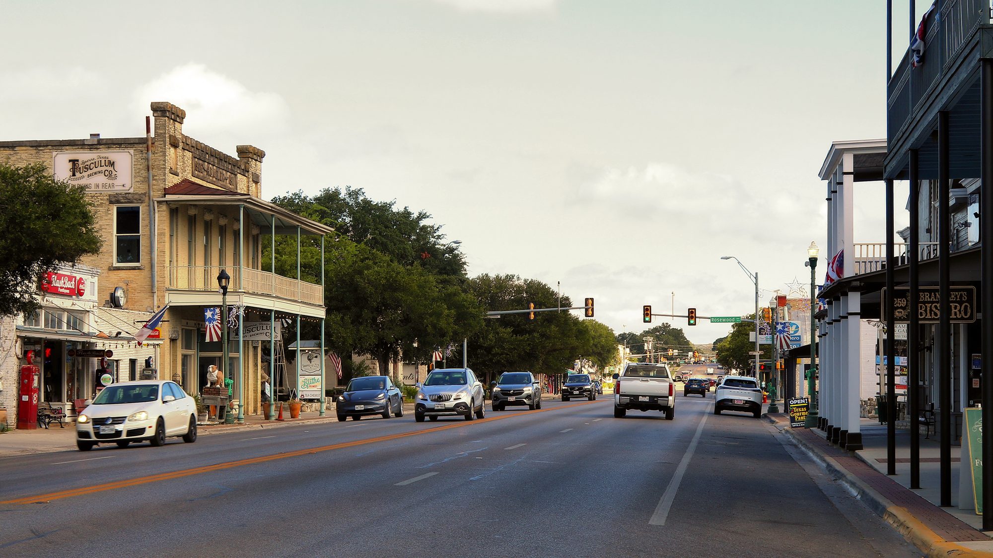 Main Street in Boerne, lined with historic limestone storefronts and shade trees
