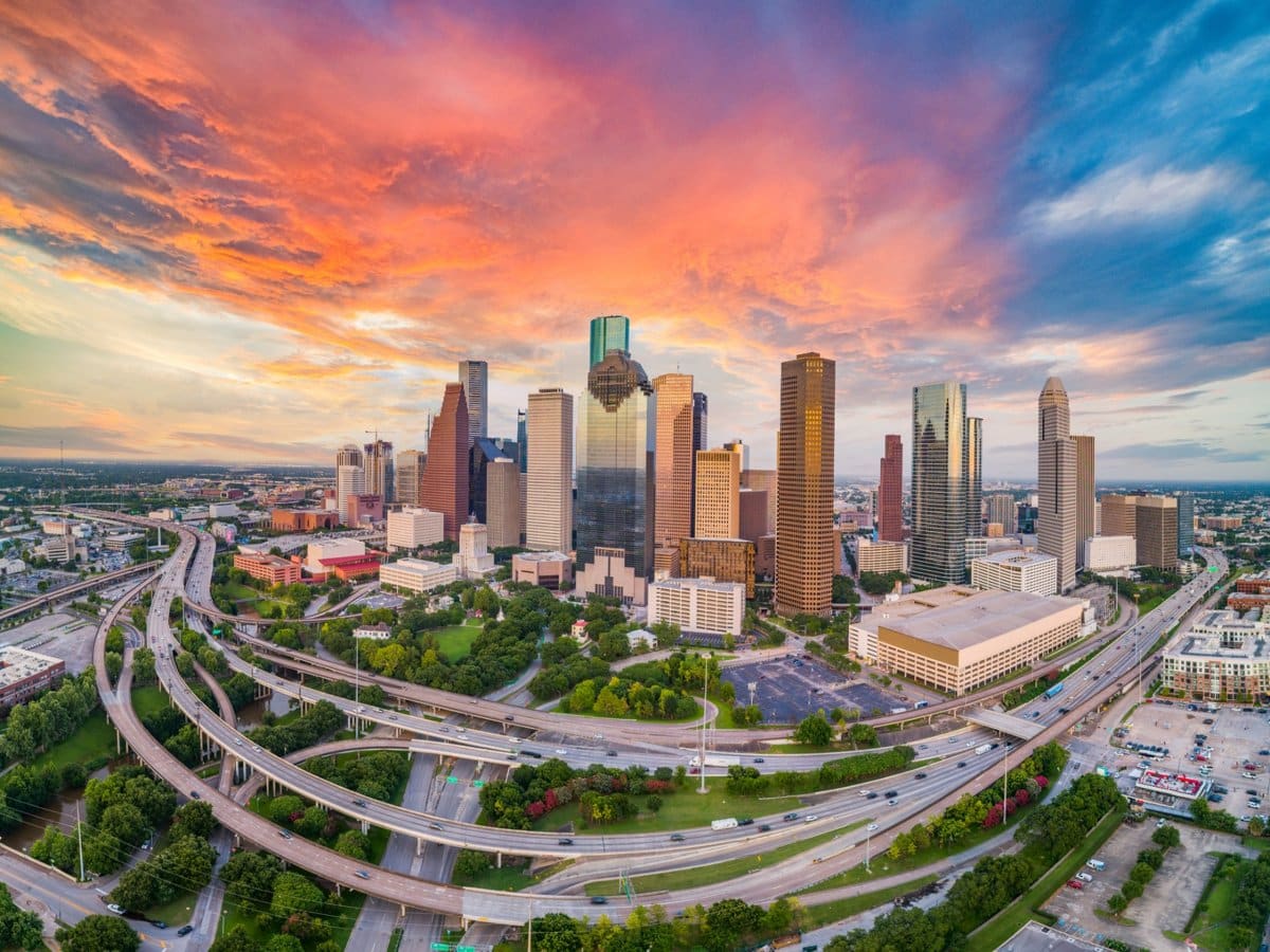 The Houston skyline above the freeway interchange at sunset