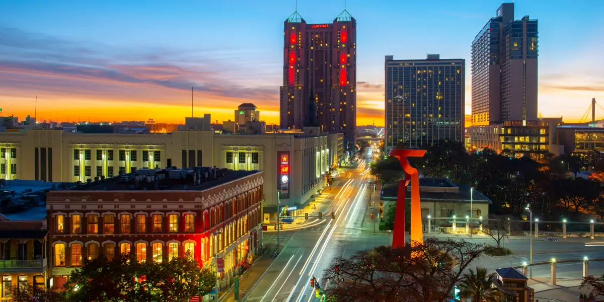 Downtown San Antonio at dusk with the red Torch of Friendship sculpture